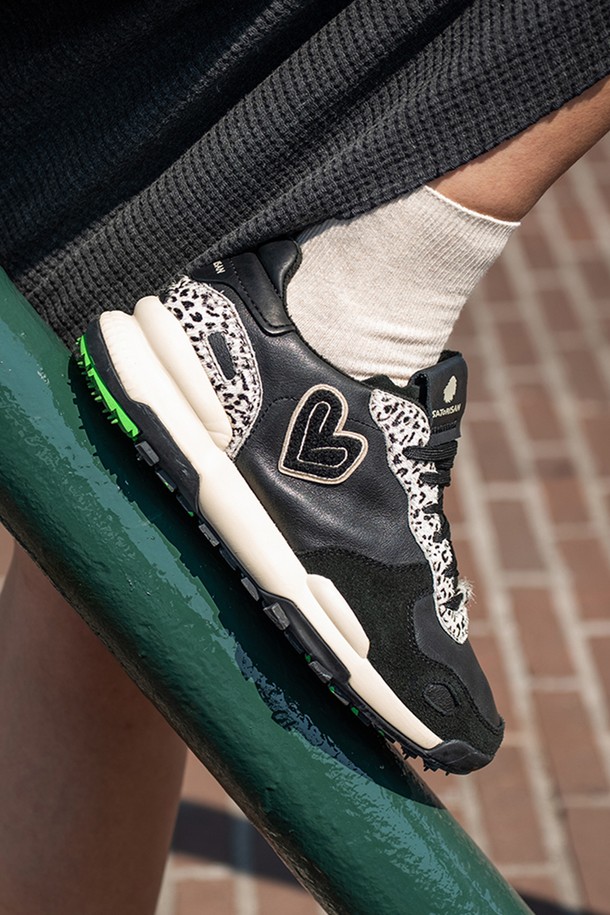 [사토리산] 차크로나 프리미엄 스니커즈 오자크 블랙 1200900507는 여성들을 위한 캐주얼, 스포티, 미니멀 스타일의 스니커즈입니다. 블랙 컬러의 합성가죽 소재, 라운드 앞코, 끈형 여밈 디자인으로 일상, 러닝 등의 다양한 TPO에 활용 가능합니다. 봄, 여름, 가을 계절에 적합하며, 로우탑 디자인과 경량, 쿠션감 등의 특징으로 편안한 착용감을 제공합니다. 프린트 패턴이 돋보이며 발볼은 일반으로 제작되었습니다.
