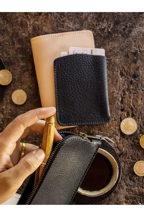 다크 브라운 색상의 인트로 명함지갑은 소가죽 소재로 제작되었으며, GOTS 인증 유기농 면 내부와 황동 하드웨어, YKK 지퍼를 사용했습니다. 스몰 사이즈의 사각 형태 명함지갑으로, 로고 엠보싱 장식이 돋보이며, 베지터블 태닝 풀그레인 가죽으로 수작업 제작되어 장인의 서명이 담겨 있습니다. 지퍼형 잠금방식과 수납 기능을 갖춘 미니 사이즈의 공용 명함지갑입니다.
