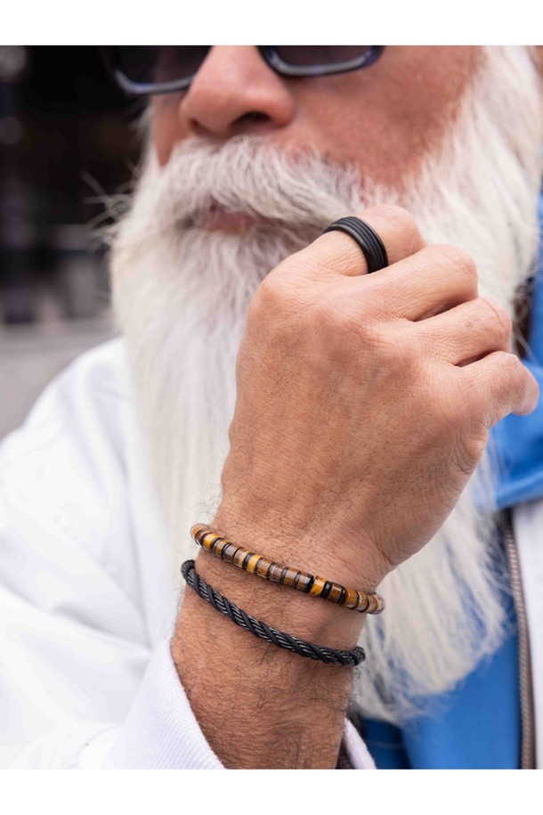 브론타이드 6 팔찌는 타이거아이와 블랙 컬러의 조화가 돋보이는 공용 쥬얼리입니다. 6mm 두께의 로프, 스테인리스 스틸, 천연석 소재로 제작되었으며, 번개 모티프와 브랜드 각인, 수작업 매듭 디자인이 특징입니다. 방수, 내구성, 내염성, 내부식성 기능은 물론 레이어드 연출과 착용감, 위생적인 관리까지 고려하여 일상과 수상 스포츠 활동 모두에 적합합니다.
