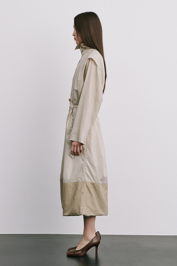 문(Moon) 자 모양의 베이지색 트렌치코트는 여성스러움을 강조한 미니멀하고 모던한 스타일의 아우터입니다. 얇은 나일론 소재로 제작되어 가볍고 산뜻한 착용감을 선사하며, 봄, 가을 간절기에 활용하기 좋습니다. 밑단이 어깨선까지 연결되는 독특한 디자인과 허리 벨트 구성으로 시크한 분위기를 연출하며, 롱 기장과 루즈핏으로 편안하게 착용할 수 있습니다. 출근룩, 오피스룩, 데이트룩 등 다양한 TPO에 활용하여 클래식하면서도 세련된 스타일을 완성해 보세요.
