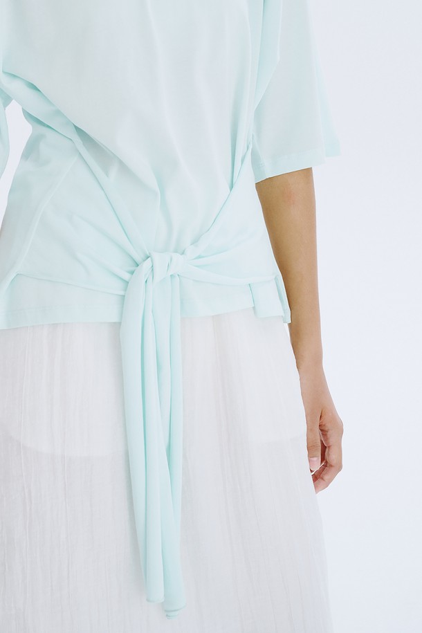Waist Tied T_Mint는 부드러운 면 소재의 여성용 티셔츠입니다. 민트, 라이트블루, 화이트 세 가지 색상으로 출시되었으며, 루즈핏과 반소매 디자인으로 편안한 착용감을 선사합니다. 허리 스트랩으로 실루엣 조절이 가능하며, 얇은 두께감과 라운드넥 디자인으로 봄, 여름철 일상복으로 활용하기 좋습니다.
