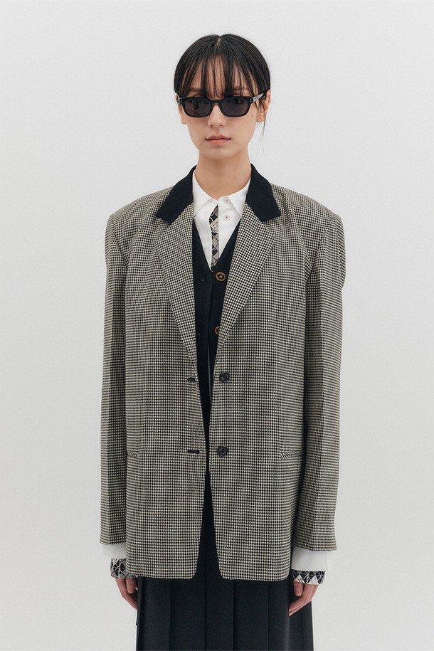 블랙과 아이보리 배색이 세련된 조화를 이루는 여성 블레이저입니다. 울 소재로 제작되어 부드러운 촉감과 고급스러운 분위기를 선사하며, 봄, 가을 시즌에 적합합니다. 싱글버튼 여밈과 스트레이트 핏으로 모던하고 클래식한 스타일을 연출하며, 오피스룩, 출근룩, 모임룩 등 다양한 TPO에 활용할 수 있습니다. 숄더 패드, 카라 배색, 안감 배색 디테일이 돋보이며, EENK 각인 소뿔 단추와 파이핑 포켓으로 디자인의 완성도를 높였습니다. 미니멀하고 시크한 스타일을 선호하는 분들께 추천합니다.
