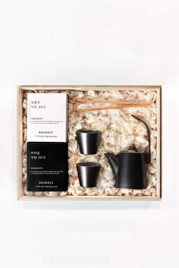 [브라운즈] 저녁바람 보이차 티백 2종 다도 선물세트는 2012년산 자연숙성 보이차와 2013년산 완전숙성 보이차 티백 2종을 포함하며, 도자기 다관세트, 대나무 차 집게로 구성되어 소중한 분들께 품격 있는 차 문화를 선물하기 좋습니다. 중국 운남성 원산의 보이차는 오동나무 상자에, 다관은 255ml, 차잔은 70ml 용량이며, 티백은 2.08g x 10ea (2종)로 제공됩니다. 무유약 내부의 도자기 다관은 자연 건조가 필요하며, 식기세척기 사용은 불가합니다.
