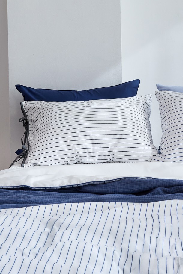 블롬 리본 순면 베개커버 50x70은 부드러운 촉감의 40수 평직 면 소재로 제작되었습니다. 스칸디나비안 스타일의 스트라이프 패턴과 리본 디자인이 특징이며, 블루와 그레이 두 가지 색상 중 선택 가능합니다. 봉투형 디자인과 지퍼 없는 구조로 편리하게 사용할 수 있으며, KATRI 유해물질 테스트를 통과하여 안심하고 사용할 수 있습니다. 70x50cm 사이즈로, 일상생활에서 편안한 잠자리를 선사합니다.
