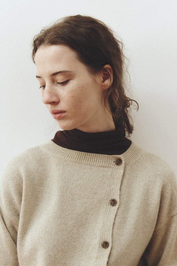 SOFT WOOL JERSEY TOP_브라운은 부드러운 울 소재로 제작된 여성용 하이넥 긴소매 상의입니다. 가을, 겨울 시즌에 어울리는 두꺼운 두께감으로 포근하게 착용할 수 있으며, 레귤러 핏으로 편안함을 더했습니다. 미니멀하고 베이직한 디자인으로 출근룩은 물론 다양한 일상 스타일에도 활용하기 좋습니다. 브라운 색상과 무지 패턴은 어떤 하의에도 매치하기 용이하며, 버튼 디테일이 은은한 포인트를 더합니다.
