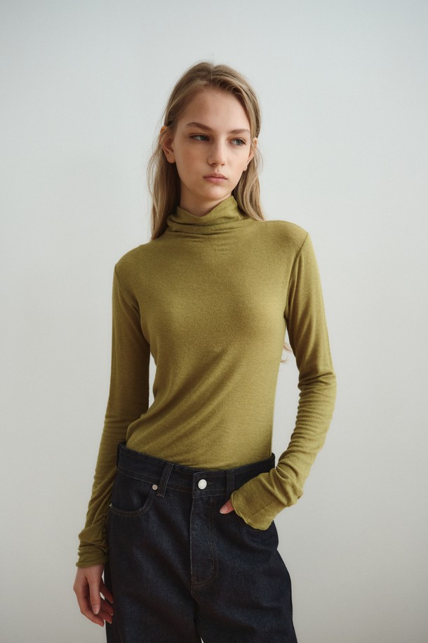 SOFT WOOL JERSEY TOP_올리브는 부드러운 촉감의 울 저지 소재로 제작된 여성 상의입니다. 올리브와 아이보리 두 가지 색상으로 출시되었으며, 가을과 겨울에 착용하기 좋습니다. 하이넥 디자인과 슬림핏으로 미니멀하고 시크한 스타일을 연출하며, 긴 소매와 소매 커프스 디테일이 특징입니다. 두꺼운 두께감으로 보온성을 높였으며, 스트레치 소재로 편안한 착용감을 선사합니다. 레이어드 스타일링이 가능하여 겨울 데일리룩, 오피스룩, 모임룩 등 다양한 TPO에 활용할 수 있습니다.
