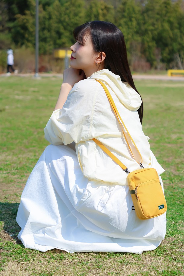 "트래블러 미니 크로스백"은 여행룩과 미니멀, 캐주얼 스타일에 잘 어울리는 여성용 가방입니다. 가볍고 방수 기능이 있는 나일론 소재로 제작되어 일상생활뿐만 아니라 여행 시에도 유용하게 사용할 수 있습니다. 만다린, 머스타드, 블랙 세 가지 색상으로 출시되었으며, 탈부착 가능한 스트랩과 외부 지퍼 포켓, 메쉬 포켓이 있어 수납력을 높였습니다. 미니 사이즈로 스마트폰, 여권 등 꼭 필요한 소지품을 간편하게 수납할 수 있으며, 매트 마감으로 세련된 느낌을 더했습니다. 지퍼형 잠금 방식으로 내용물을 안전하게 보호합니다.
