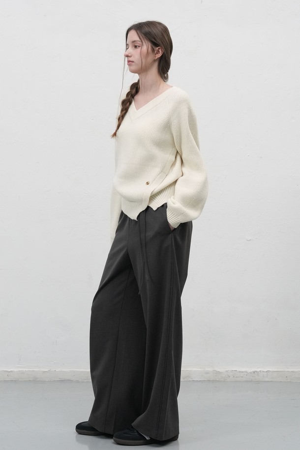 **[25FW] WOMAN 브이넥 슬릿 하찌 니트 풀오버 [3COL] /WBE3L05531**

부드러운 촉감의 여성용 브이넥 슬릿 하찌 니트 풀오버입니다. 가을과 겨울에 어울리는 두꺼운 두께감으로 따뜻하게 착용 가능하며, 루즈핏 디자인으로 편안한 착용감을 선사합니다. 아이보리, 차콜, 카키 3가지 색상으로 출시되었으며, 베이직한 스타일을 좋아하는 여성분들께 추천합니다. 비대칭 슬릿 디테일과 벌룬 소매, 하단 로고 디테일이 돋보이며, 신축성이 있어 활동성을 높였습니다. 겨울 데일리룩, 모임룩, 카페룩 등 다양한 TPO에 클래식, 미니멀, 캐주얼 스타일로 활용하기 좋습니다.
