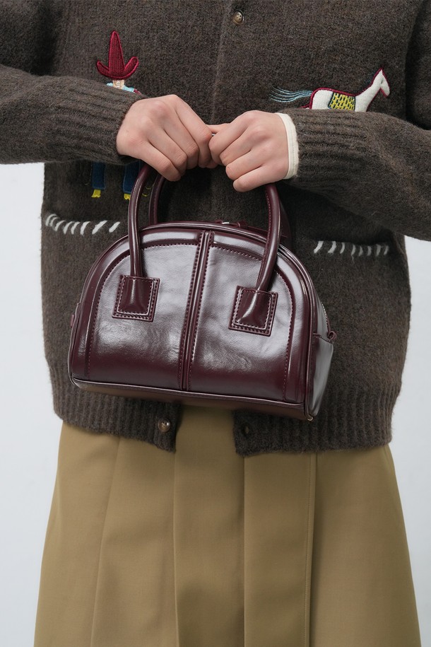 세련된 여성의 스타일을 완성해 줄 [25FW] WOMAN 라운드 미니 토트백입니다. 부드러운 합성가죽 소재로 제작되었으며, 라운드 디자인과 사각 쉐입이 조화롭게 어우러져 클래식, 미니멀, 시크한 분위기를 연출합니다. 데이트룩, 모임룩 등 다양한 TPO에 활용하기 좋으며, 미니멀한 사이즈에 지퍼형 잠금 방식으로 소지품을 안전하게 보관할 수 있습니다. 와인 컬러가 세련된 무드를 더하며, 핸들 디자인으로 실용성을 높였습니다.
