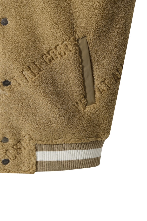 베이지 컬러의 남성용 부클 바시티 재킷입니다. 플리스와 부클 소재를 사용하여 부드러운 촉감과 두꺼운 두께로 뛰어난 보온성을 제공합니다. 스포티하면서도 캐주얼한 스타일로, 골프룩 또는 일상복으로 활용하기 좋습니다. 넥, 소매, 밑단에 니트 시보리를 적용하여 편안함과 안정감을 더했습니다. 레귤러 핏의 긴 소매 버튼 여밈 방식의 자켓으로, 로고 패턴이 특징입니다.
