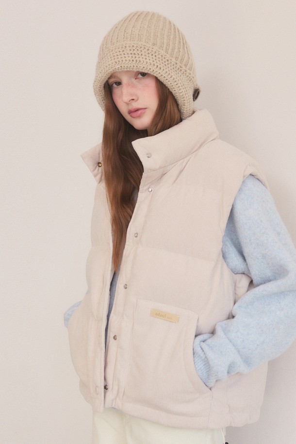 따뜻하고 부드러운 코듀로이 소재의 오버핏 패딩 베스트입니다. 베이직한 디자인에 크롭 기장과 퀄팅 디테일로 포인트를 주어 캐주얼하면서도 스타일리시한 연출이 가능합니다. 가을, 겨울 시즌에 활용하기 좋은 두꺼운 두께감으로 보온성을 높였으며, 부드러운 촉감과 민소매 디자인으로 편안한 착용감을 선사합니다. 베이지, 블랙 두 가지 컬러로 출시되어 다양한 룩에 매치하기 용이하며, 버튼 여밈 방식으로 간편하게 착용할 수 있습니다. 여성스러운 스타일을 더욱 돋보이게 해주는 아이템입니다.
