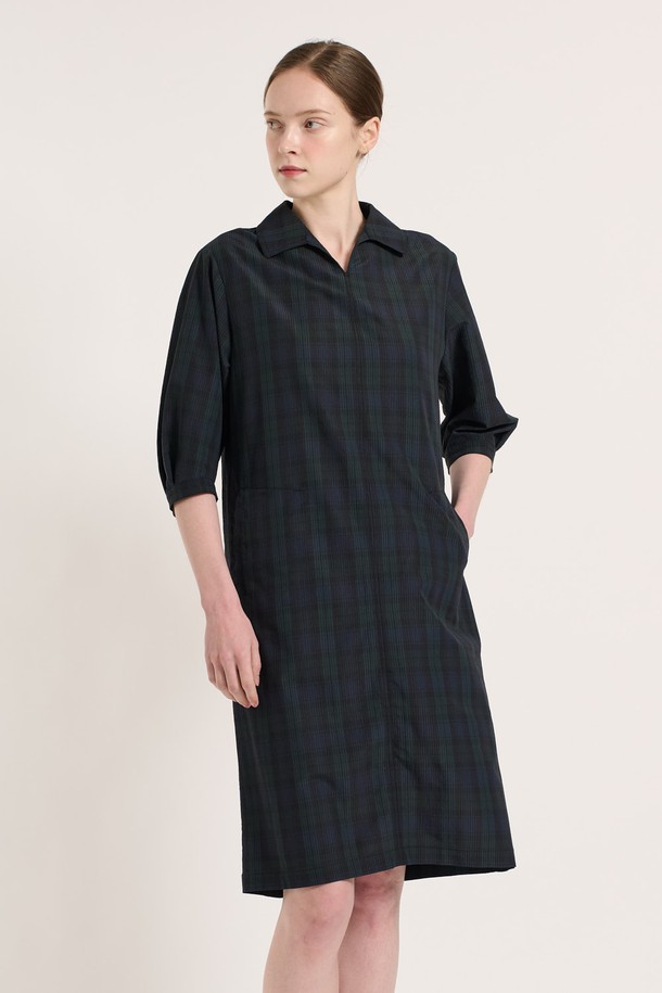 [25SU] 타탄 체크 원피스 - NAVY는 네이비 컬러의 클래식한 무드를 담은 여성용 7부 타탄 체크 원피스입니다. 폴리에스터, 나일론, 면 혼방 소재로 제작되었으며, 여유로운 핏과 소매 턱 디테일, 인 포켓 디자인이 특징입니다. 뒤 지퍼 클로징으로 편안하게 착용 가능하며, 일상복으로 좋은 여름 시즌 아이템입니다.
