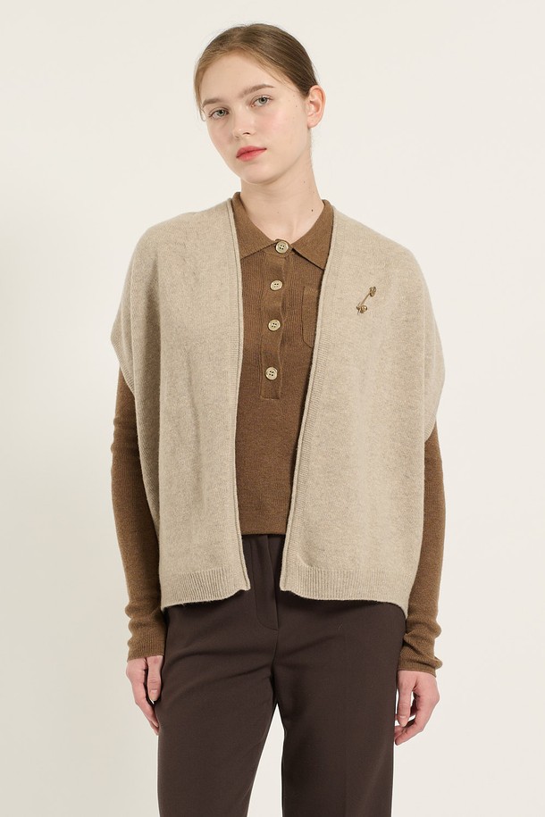 [24WT] 홀가먼트 베스트 - LIGHT BEIGE B4D9K50571는 부드러운 촉감의 모 90%, 캐시미어 10% 혼방 소재로 제작된 여성용 베스트입니다. 간절기에 착용하기 좋으며, 미니멀하고 베이직한 스타일을 연출할 수 있습니다. 브이넥 디자인에 얇은 두께감으로 가볍게 걸칠 수 있으며, 전면 중앙의 탈부착 가능한 브로치 디테일이 특징입니다. 목이 답답하지 않아 편안하며, 유연한 짜임으로 자연스러운 핏을 선사합니다. 데이트룩, 카페룩, 모임룩 등 다양한 TPO에 클래식하면서도 미니멀한 스타일을 더할 수 있습니다.
