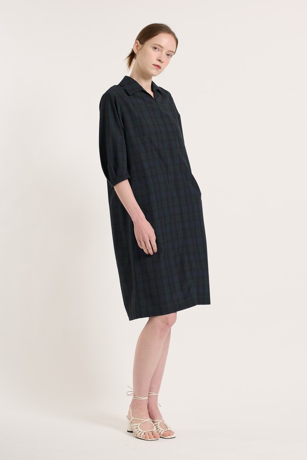 [25SU] 타탄 체크 원피스 - NAVY는 네이비 컬러의 클래식한 무드를 담은 여성용 7부 타탄 체크 원피스입니다. 폴리에스터, 나일론, 면 혼방 소재로 제작되었으며, 여유로운 핏과 소매 턱 디테일, 인 포켓 디자인이 특징입니다. 뒤 지퍼 클로징으로 편안하게 착용 가능하며, 일상복으로 좋은 여름 시즌 아이템입니다.
