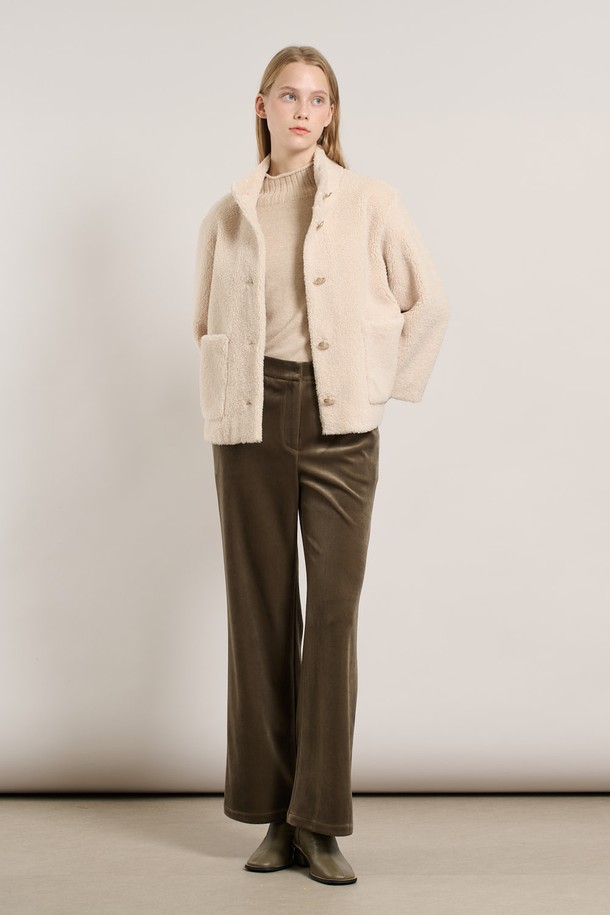 [25WT] 밴드넥 FAKE 무스탕 - IVORY A5WAF81513은 부드러운 촉감의 인조 가죽 소재로 제작된 여성용 무스탕입니다. 밴드넥 디자인과 크롭 기장으로 캐주얼하고 베이직한 스타일을 연출하며, 겨울철 따뜻하게 착용할 수 있습니다. 아이보리 컬러의 무지 디자인에 레귤러 핏으로 어떤 옷에도 쉽게 매치할 수 있습니다. 안감은 퍼 소재로 되어 있어 보온성을 높였으며, 긴 소매와 버튼 여밈 방식이 특징입니다.