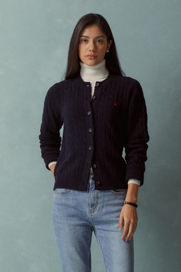 네이비 컬러의 여성 울 케이블 가디건 (BBWCWBF402)입니다. 부드러운 울 소재에 두꺼운 두께감으로 가을, 겨울 시즌에 따뜻하게 착용하기 좋습니다. 베이직하고 클래식한 스타일로, 라운드넥과 레귤러핏 디자인이 특징입니다. 긴 소매와 버튼 여밈 디테일, 그리고 크롭 디자인으로 다양한 룩에 매치하기 용이합니다. 겨울 데일리룩, 오피스룩, 모임룩 등 다채로운 TPO에 활용 가능한 아이템입니다.
