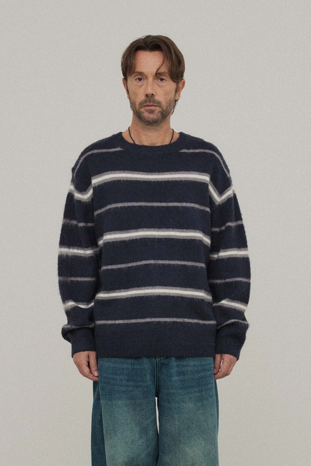네이비 컬러의 스트라이프 크루넥 니트입니다. 울과 아크릴 혼방 소재로 제작되어 부드러운 촉감과 두꺼운 두께감으로 가을, 겨울철 따뜻하게 착용하기 좋습니다. 루즈핏으로 편안한 착용감을 선사하며, 베이직하고 캐주얼한 스타일을 연출합니다. 출근룩과 비즈니스 캐주얼, 캐주얼, 클래식, 미니멀 스타일 모두 소화 가능합니다. 긴 소매 기장과 스트라이프 패턴 디테일이 돋보이는 디자인입니다.
