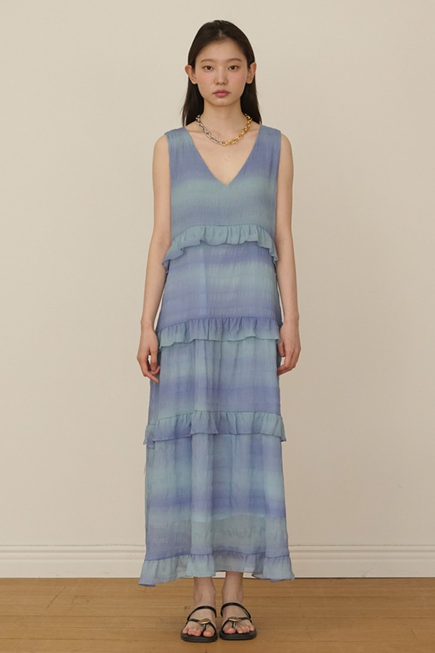 블루 미스트 색상의 Sleeveless Ruffle Tiered 롱 드레스입니다. 얇고 부드러운 시폰 소재로 제작되어 쿨터치 촉감을 선사하며, 봄, 여름 계절에 시원하게 착용하기 좋습니다. V넥 라인과 릴랙스 핏 디자인으로 편안하면서도 로맨틱하고 페미닌한 무드를 연출합니다. 티어드 치마와 러플 디테일, 캐스케이딩 러플이 더해져 여성스러운 실루엣을 강조하며, 데이트룩, 휴가룩, 리조트룩에 잘 어울립니다.
