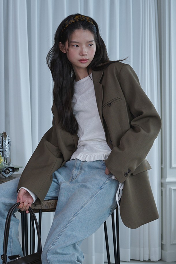 오버핏 백 슬릿 블레이저_브라운은 여성용 아우터로, 간절기와 초겨울에 착용하기 좋습니다. 미니멀한 스타일의 무지 디자인이며, 뻣뻣한 촉감의 폴리에스테르와 스판덱스 혼방 소재로 제작되었습니다. 오버핏 레귤러 기장의 싱글 버튼 블레이저로, 백 슬릿 디테일과 숄더 패드, 왼쪽 가슴 웰트 포켓, 2버튼 디테일, 그리고 주름 방지 가공이 특징입니다. 오피스룩, 출근룩, 모임룩 등 다양한 TPO에 활용 가능하며, 클래식, 미니멀, 시크한 스타일을 연출할 수 있습니다.
