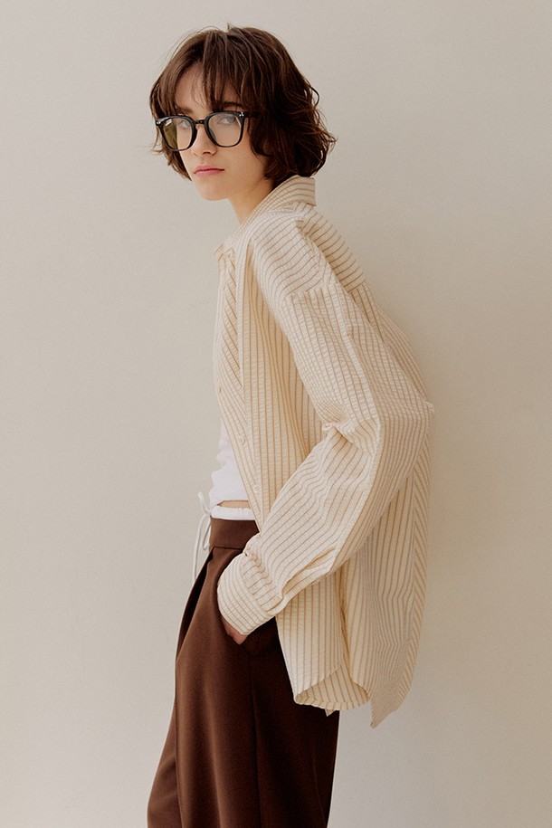 [2차 리오더] 시어서커 오버핏 스트라이프 셔츠 [브라운]는 시원한 시어서커 소재로 제작되어 봄, 여름에 쾌적하게 착용하기 좋습니다. 얇은 두께감과 부드러운 촉감으로 편안함을 더하며, 차이나칼라와 오버핏 디자인으로 캐주얼하고 트렌디한 스타일을 연출합니다. 브라운, 핑크, 그린 세 가지 컬러의 스트라이프 패턴으로 다양한 코디에 활용 가능하며, 사이드 슬릿 디테일로 활동성을 높였습니다. 데이트룩, 카페룩 등 다양한 TPO에 맞춰 단독 또는 레이어드하여 개성 있는 스타일을 완성해 보세요.
