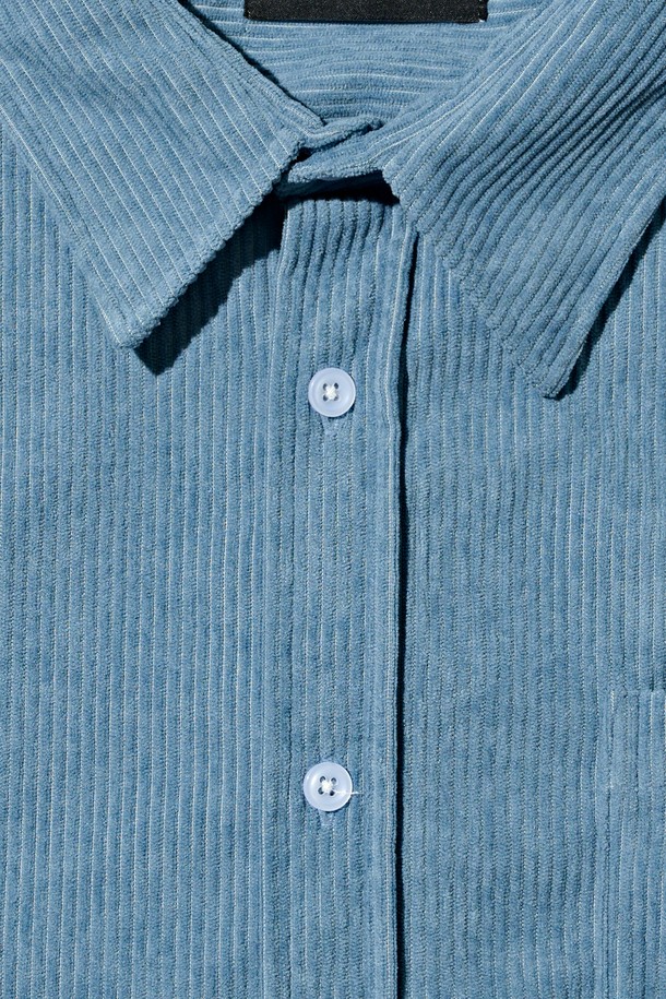 클래식 코듀로이 세미 셔츠 (블루)는 가을과 겨울에 어울리는, 부드러운 촉감의 두꺼운 코듀로이 소재로 제작된 남녀 공용 셔츠입니다. 차이나 칼라와 루즈핏 디자인으로 클래식하면서도 캐주얼한 스타일을 연출하며, 출근룩이나 비즈니스 캐주얼에 활용하기 좋습니다. 긴 소매와 포켓 디테일이 돋보이며, 무지 패턴의 블루 컬러가 미니멀한 무드를 더합니다. 
