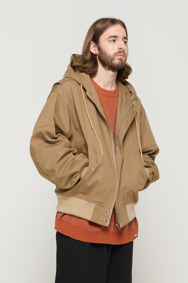 베이지 색상의 후드 밀리터리 자켓으로, 봄과 가을에 캐주얼하게 착용하기 좋습니다. 면 소재로 제작되었으며, 후드 디자인과 바이저, 커버드 지퍼, 다양한 절개 라인이 특징입니다. 남성용 레귤러 핏의 긴소매 집업 스타일로, 밀리터리 무드를 연출할 수 있습니다.
