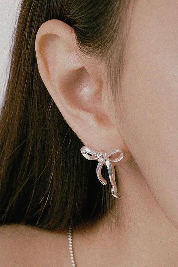 리본 타이 귀걸이는 여성스러운 스타일을 완성하는 데일리 귀걸이입니다. 실버925 소재로 제작되어 알레르기 걱정 없이 착용 가능하며, 하이포알러제닉 기능으로 민감한 피부에도 안심하고 사용할 수 있습니다. 미니멀하면서도 엘레강스한 무드를 연출하며, 내추럴한 매듭 스타일의 리본 디자인과 메탈릭 텍스처가 세련된 포인트를 더합니다. 데이트룩, 모임룩 등 다양한 TPO에 맞춰 클래식, 로맨틱 스타일을 연출해보세요.
