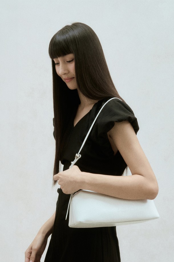 미스트 컬러의 바게트 쉐입 가죽 숄더백입니다. 부드러운 소가죽 소재로 제작되었으며, 미디엄 사이즈에 무지 디자인으로 클래식하고 모던한 스타일을 연출합니다. 숄더백과 크로스백 두 가지 방식으로 활용 가능하며, 내부 포켓이 있어 실용적입니다. 투웨이 지퍼와 길이 조절 가능한 스트랩, 시그니처 로고 디테일이 특징이며, 일상에서 편안하게 사용할 수 있습니다. 
