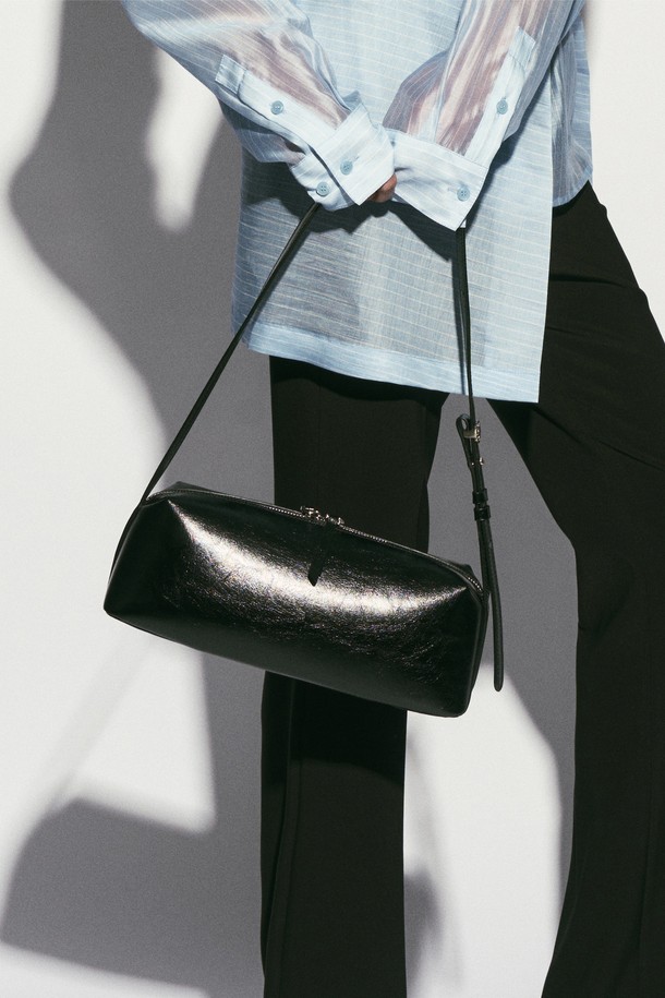 바게트 카우하이드 숄더백 블랙은 여성용 미디엄 사이즈 바게트백입니다. 소가죽 소재에 무지 패턴, 빈티지한 광택과 크랙 텍스처가 특징이며, 시그니처 로고 실링 루프와 내부 로고 가죽 바인딩으로 디자인 포인트를 더했습니다. 투웨이 지퍼 잠금 방식으로 편리하며, 내부 오픈 포켓과 조절 가능한 스트랩으로 실용성을 높였습니다. 클래식, 모던, 빈티지 스타일을 아우르며, 모임룩과 데이트룩에 잘 어울립니다.
