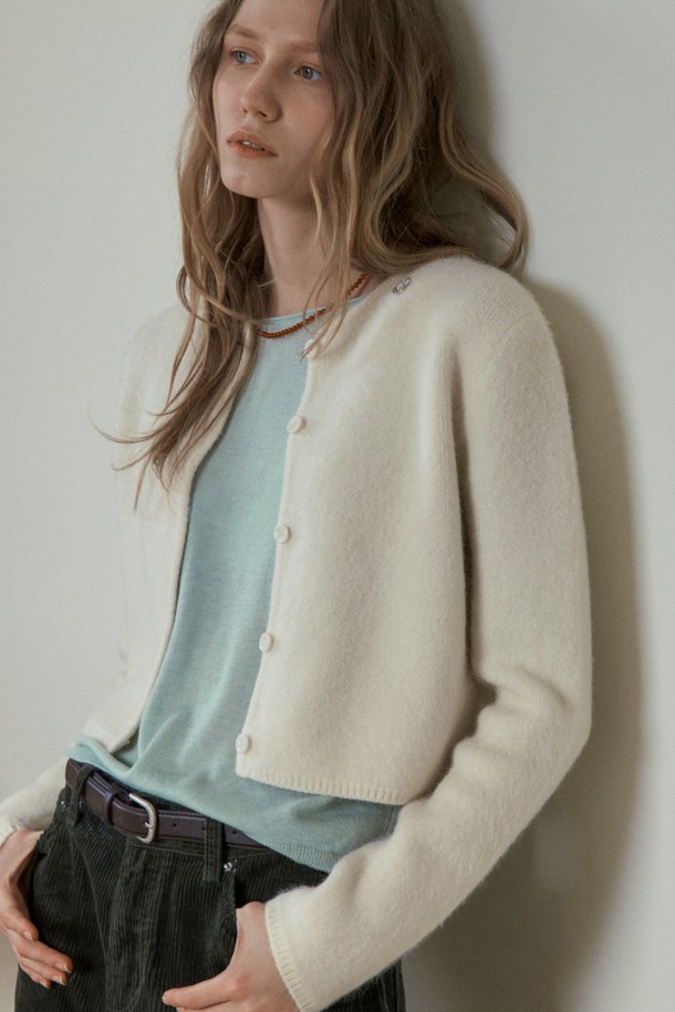 BERY 앙고라 크롭 가디건_아이보리는 여성 의류로, 가을과 겨울에 따뜻하게 입을 수 있는 제품입니다. 부드러운 촉감의 앙고라 소재를 사용하여 포근함을 더했으며, 베이직하고 미니멀한 스타일로 다양한 룩에 활용하기 좋습니다. 라운드넥에 긴소매, 레귤러핏으로 디자인되었으며, 크롭 기장과 버튼 여밈 방식이 특징입니다. 데이트룩, 모임룩 등 TPO에 맞춰 클래식, 미니멀, 캐주얼 스타일을 연출할 수 있습니다.
