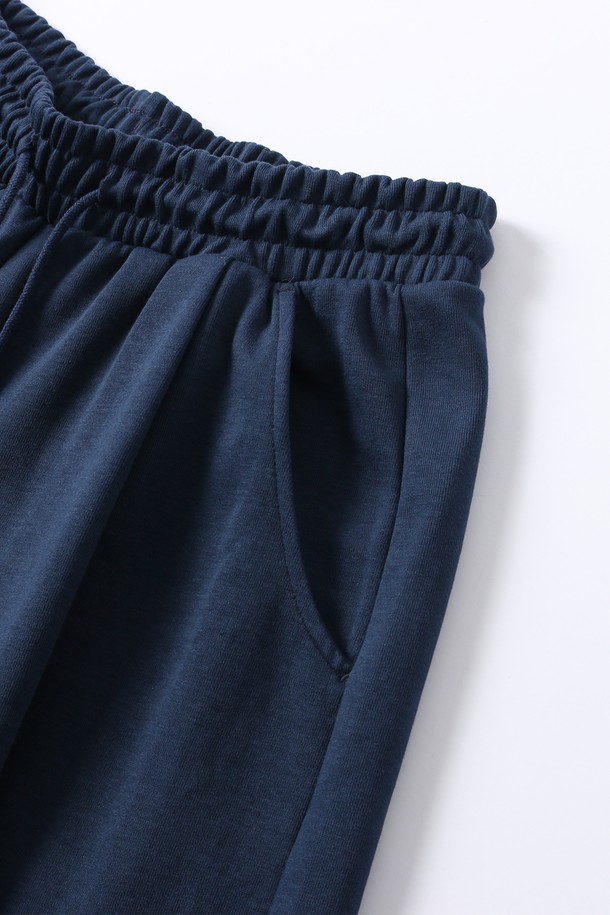 다크블루 색상의 남녀공용 풀밴딩 원턱 버뮤다 팬츠입니다. 넉넉한 루즈핏으로 편안한 착용감을 선사하며, 여름철 캐주얼, 미니멀, 리조트 스타일을 연출하기 좋습니다. 여행, 휴가, 바캉스룩에 활용하기 좋은 5부 기장의 버뮤다 팬츠는 무지 디자인으로 어떤 상의와도 쉽게 매치됩니다. 풀밴딩 허리 디자인과 원턱 디테일로 활동성을 높였습니다.
