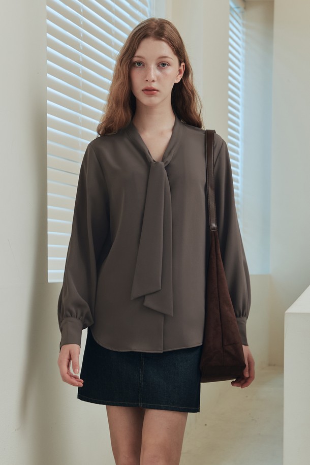 우아하고 클래식한 무드의 타이 블라우스입니다. 부드러운 촉감의 고급 폴리에스테르 소재로 제작되어 편안하게 착용 가능하며, 적당한 두께감으로 봄, 가을에 활용하기 좋습니다. 타이 디테일이 돋보이며, 루즈핏으로 자연스러운 실루엣을 연출합니다. 오피스룩, 모임룩, 소개팅룩 등 다양한 TPO에 잘 어울리며, 미니멀한 스타일을 선호하는 여성분들께 추천합니다. 브라운 컬러는 세련된 분위기를 더합니다.
