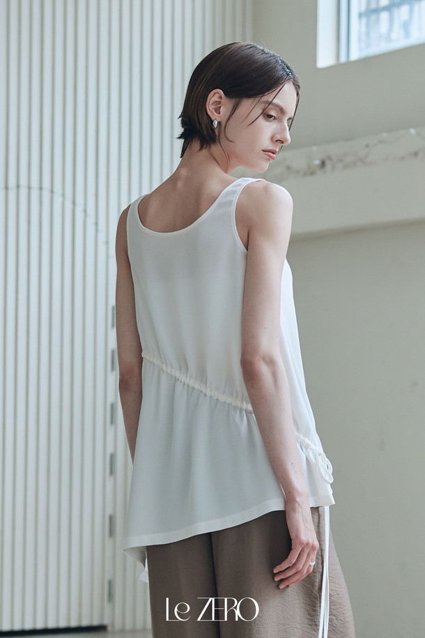 르제로 플레어 언발란스 슬리브리스 아이보리 컬러 제품입니다. 미니멀한 디자인에 라운드넥으로 깔끔함을 더했으며, 얇고 가벼운 폴리에스테르 소재로 제작되어 여름철 시원하게 착용할 수 있습니다. 언발란스 햄라인과 허리 스트링 디테일이 특징이며, 비침이 있을 수 있으니 주의하여 착용하십시오. 루즈핏으로 편안한 착용감을 선사합니다.
