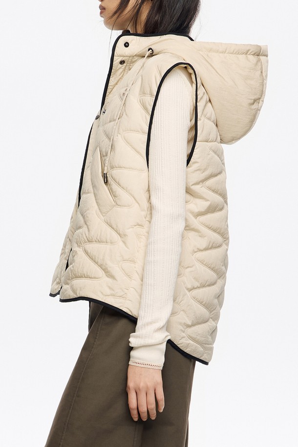 [25FW] 아이보리 후드 패딩 베스트 B256AWV002IVB는 여성용 아우터 베스트입니다. 아이보리 컬러의 무지 퀄팅 디자인으로, 가을, 겨울, 간절기에 캐주얼하게 착용하기 좋습니다. 레귤러핏에 후드 디자인이 돋보이며, 스냅 버튼으로 여밈이 가능합니다. 폴리아미드와 폴리에스터 소재로 제작되어 두께감이 있으며, 블랙 파이핑 디테일로 포인트를 더했습니다. 캐주얼, 미니멀, 클래식 스타일을 즐겨 입는 분들께 추천합니다.
