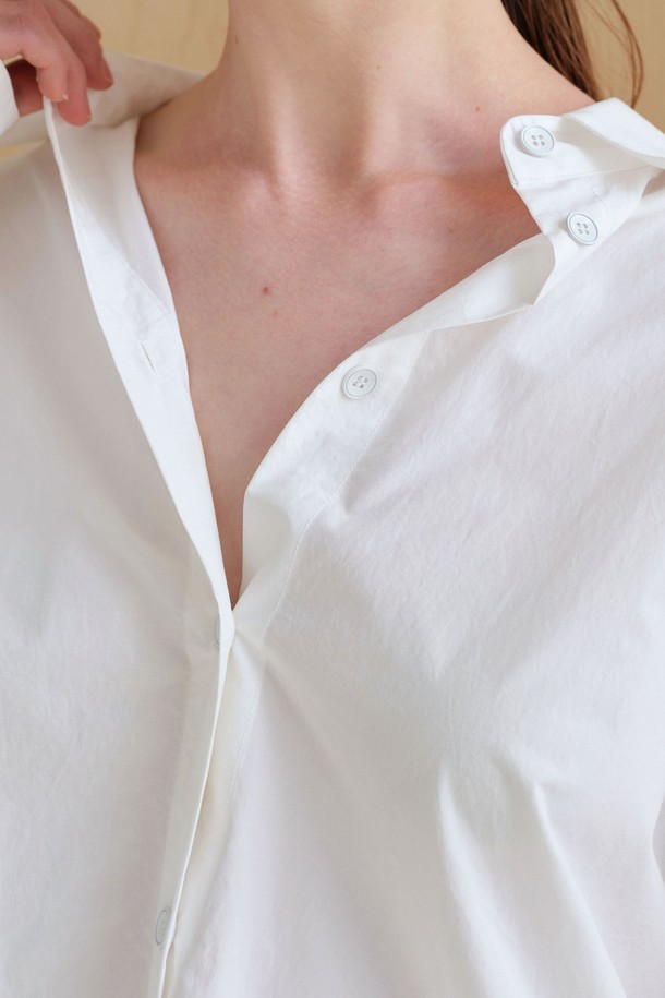 **스트링 볼륨 셔츠**

미니멀하고 베이직한 스타일의 여성용 셔츠/블라우스입니다. 아이보리 컬러의 얇은 면 소재로 제작되었으며, 봄 시즌에 적합합니다. 브이넥 디자인과 루즈핏, 오버핏의 편안한 착용감을 선사하며, 볼륨감 있는 구조적 디자인과 플리츠 디테일이 특징입니다. 뒷면 스트링 디테일로 포인트를 더했고, 60수 고밀도 바이오 원단을 사용하여 부드러운 촉감을 느낄 수 있습니다. 데이트룩, 카페룩, 미니멀, 클래식, 캐주얼 스타일을 연출하기 좋습니다.
