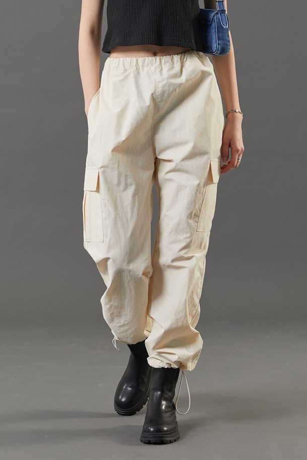 여성용 아이보리 색상의 여름 쿨링 카고 팬츠입니다. 얇고 부드러운 나일론 소재로 제작되었으며, 쿨링, 속건, 통기 기능과 바스락 소재, 투웨이 에어 서큘레이션, 365 FAST DRY 기능이 특징입니다. 와이드 핏에 밴딩 허리로 편안한 루즈핏 긴바지입니다.
