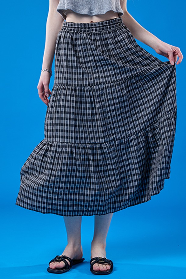 릴리 에어리 쿨링 마몽 체크 롱스커트는 여름철 일상에서 쾌적하게 착용 가능한 블랙 색상의 여성용 스커트입니다. 부드러운 폴리에스테르 소재의 A라인 티어드 디자인으로, 얇은 두께와 통기성, 냉감 및 속건 기능까지 갖춰 시원하게 입을 수 있으며, 밴딩과 안감 처리로 편안함과 비침 방지 기능까지 더했습니다. 루즈핏으로 주름 디자인이 돋보이는 체크 패턴 롱스커트입니다.
