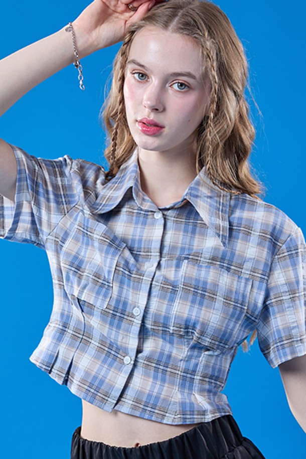 프레피 체크 패턴이 돋보이는 페일블루 컬러의 크롭 슬림 반팔 셔츠입니다. 여성스러운 실루엣을 연출하며, 카라 디자인으로 클래식한 무드를 더했습니다. 여름철 일상에서 산뜻하게 착용하기 좋은 아이템입니다.
