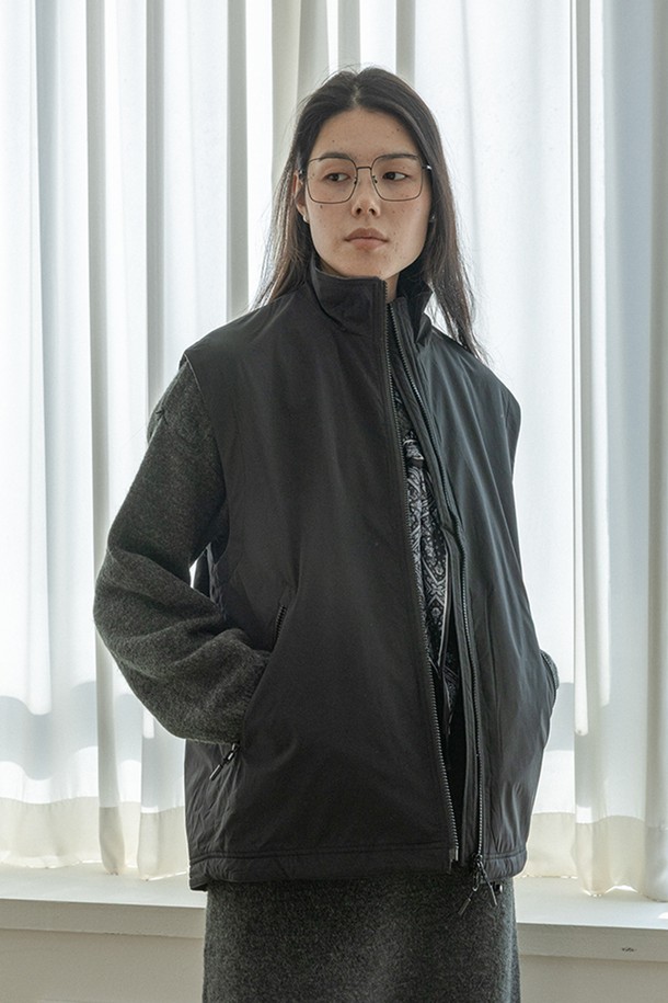 블랙 색상의 루즈핏 '집업' 베스트입니다. 부드러운 촉감의 폴리에스테르 소재로 제작되었으며, 봄, 가을 간절기에 착용하기 좋습니다. 민소매 디자인에 라운드넥으로 제작되었으며, 캐주얼하고 베이직한 스타일을 연출합니다. 얇은 두께감으로 편안하게 착용할 수 있으며, 지퍼 여밈 방식으로 간편하게 스타일링할 수 있습니다. 무지 디자인으로 다양한 룩에 활용하기 용이합니다.
