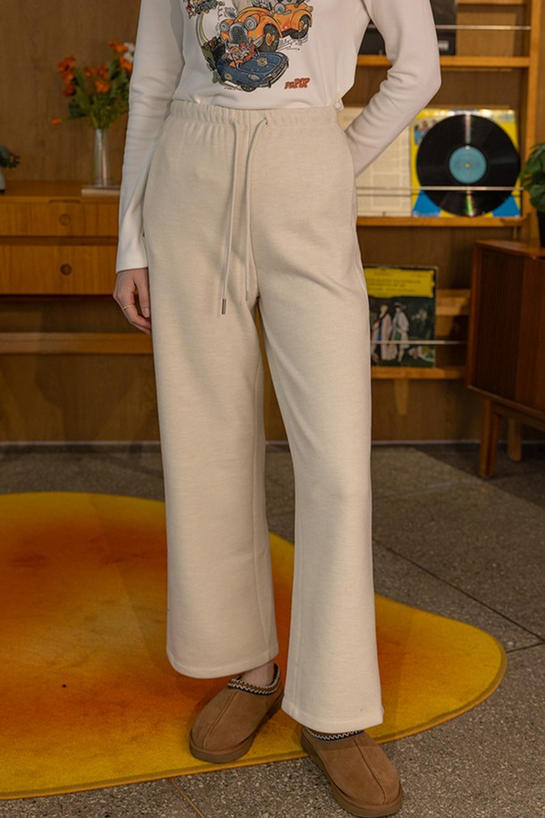 부드러운 니트 소재로 제작되어 포근한 착용감을 선사하는 드로우스트링 슬림핏 캐주얼 바지입니다. 아이보리, 블랙 두 가지 색상으로 출시되어 겨울철 다양한 상의와 매치하기 좋습니다. 허리 밴딩과 드로우스트링(조임끈) 디자인으로 편안한 착용감을 제공하며, 슬림핏으로 다리 라인을 슬림하게 연출해 줍니다. 

**TPO:** 집콕룩, 산책룩
**STYLE:** 캐주얼, 미니멀, 클래식
