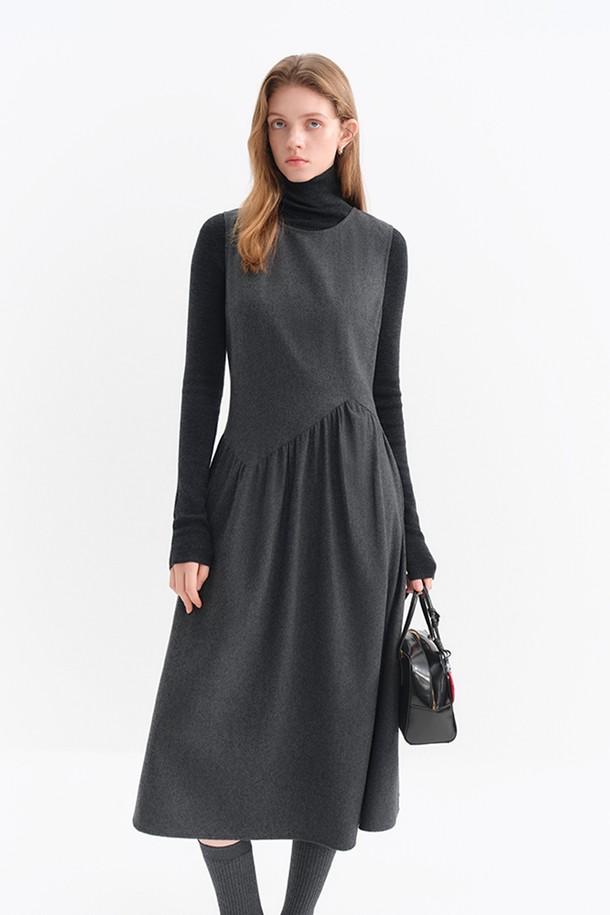 **셔링 울 민소매 원피스**는 부드러운 촉감의 울 소재로 제작되어 가을과 겨울에 따뜻하게 입을 수 있는 여성용 원피스입니다. 다크 그레이 색상에 A라인 플레어 스커트와 루즈핏으로 편안함을 더했으며, 터틀넥 디자인과 셔링 디테일이 클래식하면서도 미니멀한 스타일을 연출합니다. 출근룩과 모임룩으로 활용하기 좋으며, 민소매 디자인으로 다양한 레이어링이 가능합니다. 두꺼운 두께감으로 고급스러운 분위기를 자아냅니다.
