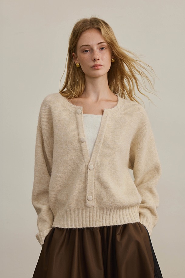 베이직하고 미니멀한 스타일의 니트 가디건입니다. 부드러운 울 소재로 제작되어 가을, 겨울 시즌에 따뜻하게 착용할 수 있습니다. 라운드넥 디자인에 긴 소매 기장, 레귤러 핏으로 편안한 착용감을 선사합니다. 무지 패턴에 버튼 디테일이 더해져 심플하면서도 세련된 느낌을 줍니다. 출근룩으로 활용하기 좋으며, 다양한 스타일과 매치하기 용이합니다.
