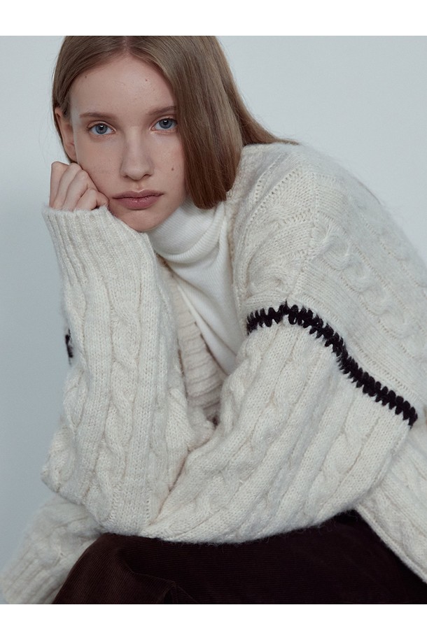 NOI (노이) COLORING LINE CABLE CARDIGAN_NFCA5266은 여성용 니트/스웨터 카테고리에 속하는 캐주얼 스타일의 가을/겨울용 긴소매 가디건입니다. 크림과 차콜 두 가지 색상으로 출시되었으며, 부드러운 촉감의 폴리에스테르, 나일론, 울, 스판덱스 혼방 소재로 제작되었습니다. 케이블 니트 패턴과 컬러 포인트 디테일이 돋보이며, 루즈핏으로 편안하게 착용 가능합니다. 코지하고 럭셔리한 분위기를 연출하여 겨울 데일리룩, 카페룩, 집콕룩 등 다양한 TPO에 활용하기 좋습니다. 클래식, 미니멀 스타일을 선호하는 분들께 추천합니다.
