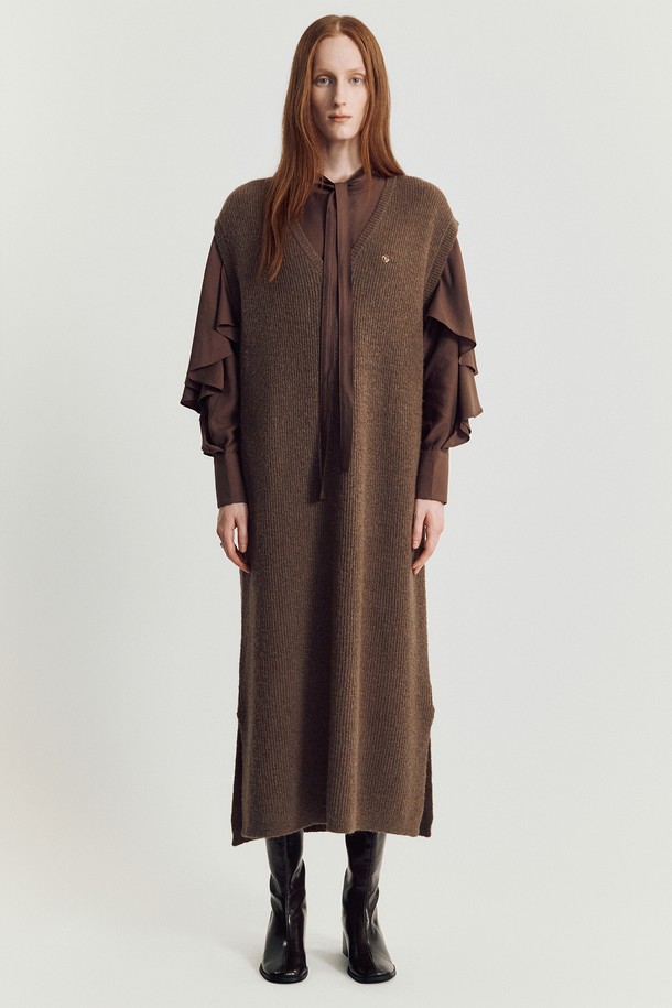 보.로디나 니트 롱 베스트 _ 브라운은 가을, 겨울 시즌에 활용하기 좋은 여성 니트 베스트입니다. 부드러운 촉감의 아크릴, 폴리에스터, 나일론, 울 혼방 소재로 제작되어 가볍고 따뜻하게 착용할 수 있습니다. 루즈핏에 브이넥 디자인으로, 미니멀하고 베이직한 스타일을 연출하며, 롱 기장과 사이드 슬릿, 드롭숄더 디테일이 특징입니다. 민소매 디자인으로 베스트 또는 드레스로도 활용 가능하며, 겨울 데일리룩에 따뜻함과 스타일을 더해줍니다.
