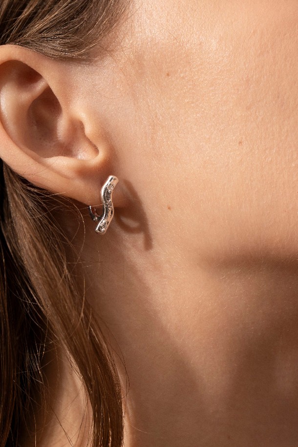 **웨이브 블룸 이어링**은 자연스러운 곡선 디자인이 돋보이는 여성용 이어링입니다. 실버925 소재에 큐빅 지르코니아를 세팅하여 은은한 광택을 더했으며, 매트한 실버 표면 질감이 고급스러운 분위기를 자아냅니다. 미니멀하면서도 우아한 스타일로, 데이트룩이나 카페룩에 세련된 포인트를 줄 수 있습니다. 심플한 디자인과 불규칙한 표면 질감이 조화롭게 어우러져 일상 속 특별함을 선사합니다.
