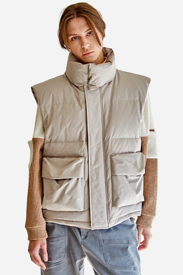 오버숄더 입체포켓 오버핏 밴드넥 다운 베스트 CTS22WWDVB51 BEI는 포근한 겨울 스타일을 완성하는 베이지 컬러의 다운 베스트입니다. 데일리, 캐주얼, 출퇴근, 데이트 등 다양한 TPO에 활용하기 좋으며, 미니멀하고 캐주얼한 무드를 연출합니다. 하이넥 디자인과 유니크한 숄더라인이 돋보이며, 입체 포켓 디테일로 수납성을 더했습니다. 부드러운 촉감의 폴리에스테르와 덕다운 소재를 사용하여 보온성을 높였으며, 깃털 빠짐 현상을 최소화했습니다. 오버핏과 퀼팅 무늬가 특징인 하프 기장의 베스트로, 스냅 버튼으로 간편하게 여밀 수 있습니다.
