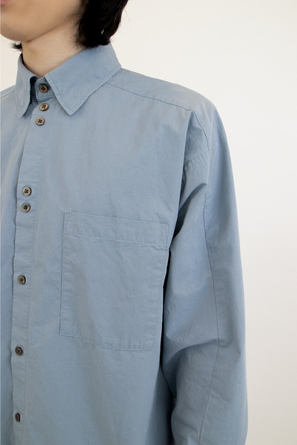 **Diagonal Seam Shirt (다이어고널 심 셔츠) - cloudy blue (클라우디 블루)**

미니멀하고 클래식한 무드의 남성 셔츠입니다. 얇고 부드러운 면 소재로 제작되어 봄, 여름, 가을 계절에 시원하게 착용하기 좋습니다. 은은한 하늘색 컬러는 어떤 룩에도 자연스럽게 어울리며, 차이나 칼라와 레귤러 핏으로 깔끔한 실루엣을 연출합니다. 자개 단추, 효소 워싱 가공, 사선 옆솔기선, 후면부 사선 절개 등 섬세한 디테일이 돋보입니다. 데이트룩, 카페룩, 비즈니스 캐주얼 등 다양한 TPO에 활용하기 좋은 아이템입니다.
