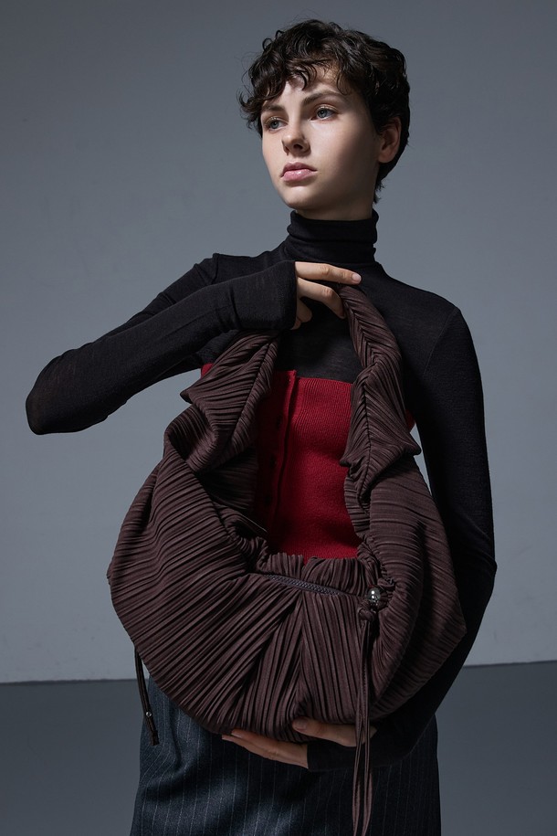 LUVITS BAG LARGE BROWN (러비츠백 라지 브라운)은 우아한 스타일을 연출하는 여성 숄더백입니다. 브라운 컬러의 라지 사이즈 반달 모양 가방으로, 주름 디테일과 태슬 장식이 돋보입니다. 숄더 스트랩과 조임용 끈 잠금 방식으로 편의성을 더했으며, 모임룩 및 일상 용도로 활용하기 좋습니다. 클래식, 미니멀, 로맨틱 스타일을 선호하는 분들께 추천합니다. 플리츠 디테일이 세련된 느낌을 더합니다.
