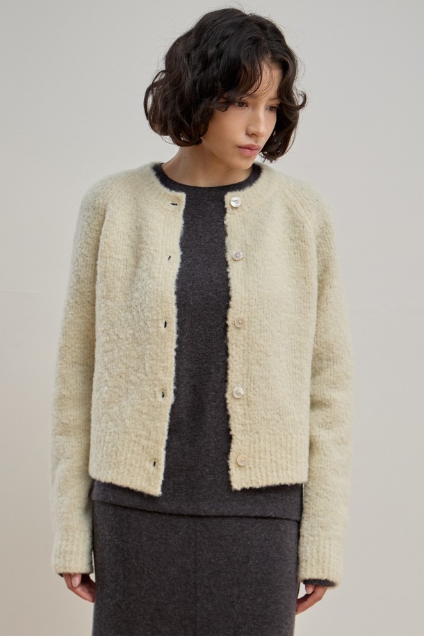 부드러운 촉감의 젠틀 부클 가디건 [크림]입니다. 포근한 울, 나일론, 스판덱스 혼방 소재로 제작되어 겨울철에도 따뜻하게 착용할 수 있습니다. 래글런 소매와 릴랙스핏 디자인으로 편안한 착용감을 선사하며, 라운드넥과 진주 단추 디테일이 클래식하고 여성스러운 분위기를 더합니다. 데이트룩, 모임룩 등 다양한 TPO에 활용 가능하며, 스커트, 팬츠 모두 잘 어울려 미니멀, 캐주얼 스타일을 연출하기 좋습니다. 크림, 카멜, 레드, 네이비 총 4가지 컬러로 만나보세요.
