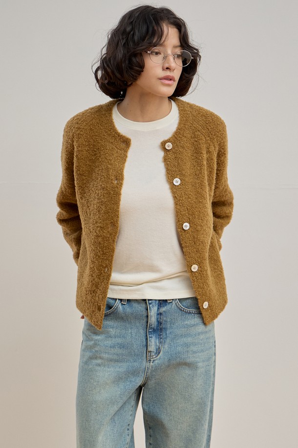 따뜻하고 포근한 젠틀 부클 가디건 [카멜]입니다. 울, 나일론, 스판덱스 혼방 소재로 제작되어 부드러운 촉감과 뛰어난 보온성을 자랑하며, 롱 기장과 릴랙스 핏으로 편안한 착용감을 선사합니다. 부클 패턴과 싱글 버튼, 래글런 소매 디테일, 그리고 은은하게 빛나는 진주 단추가 클래식하고 여성스러운 분위기를 더합니다. 출근룩, 모임룩 등 다양한 TPO에 활용 가능하며, 미니멀하고 클래식한 스타일을 즐기는 여성분들께 추천합니다. 겨울철 따뜻함과 스타일을 동시에 잡으세요.
